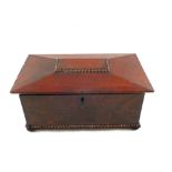 A large 19th Century Mahogany Sarcophagus shaped tea caddy with beaded decoration and bun feet