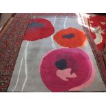 A contemporary wool rug with poppy decoration, 94" x 68"