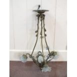 A Brass three branch light fitting with cut glass panels and rose form shades