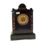 A black and red variegated marble striking mantel clock