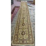 A Pakistan machine made cream and red floral runner, 193" x 29"