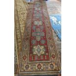 A Persian runner with central geometric design, 141" x 33"