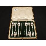 A cased set of six Silver teaspoons and tongs with engraved decoration,