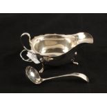 A Silver sauce boat with matching ladle,