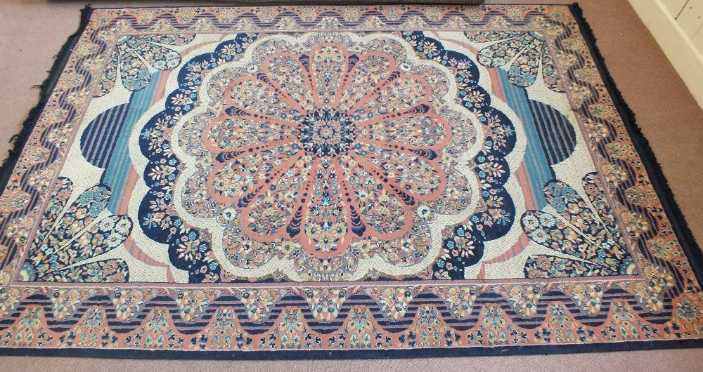 A Turkish machine made pink and floral carpet,