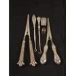Two pairs of Silver handled glove stretchers, two button hooks,