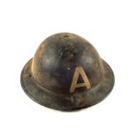 A WWII era tin helmet marked with an 'A'