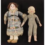 A three faced porcelain doll and a German dressed doll