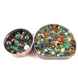 Two tins of various marbles