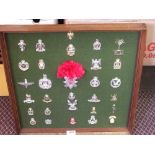 Two display boards of mainly cap badges including Suffolk Regiment and artists rifles