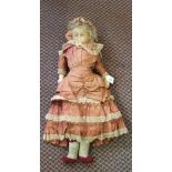 A vintage wax head dressed doll