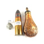 A Copper powder flask with shell case and head,