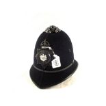 A Police helmet with Manchester Police plate (Kings Crown pre 1952)