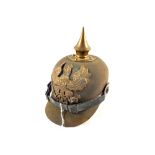 A WWI era Pickelhaube, felt example with Brass Eagle plate, chin strap and cockades intact,