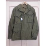 A USA WWII era M1945 jacket with shirt and trousers with insignia for the 'rail splitters'