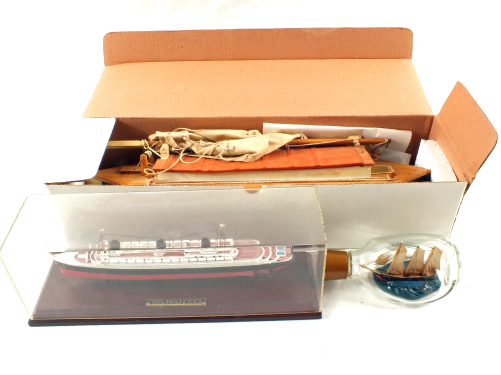 A boxed model sailing barge and two other ship models