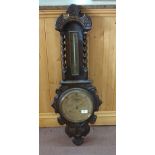 A carved Oak banjo barometer with Brass dial