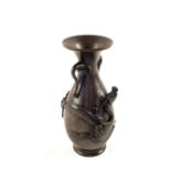 A 19th Century oriental Bronze vase with applied dragon and elephant head handles,