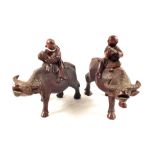 A pair of Chinese hardwood boy on Buffalo carvings