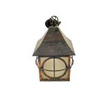 An Arts and Crafts hanging Copper hall lantern, the overhanging canopy above square glazed sides,