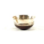 A Silver bowl with turned treen base,