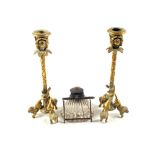 A pair of Brass rams head and lion base candlesticks and an inkwell