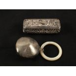 A floral embossed Silver box, Birmingham 1901 and a Silver and Mother of Pearl teething ring,