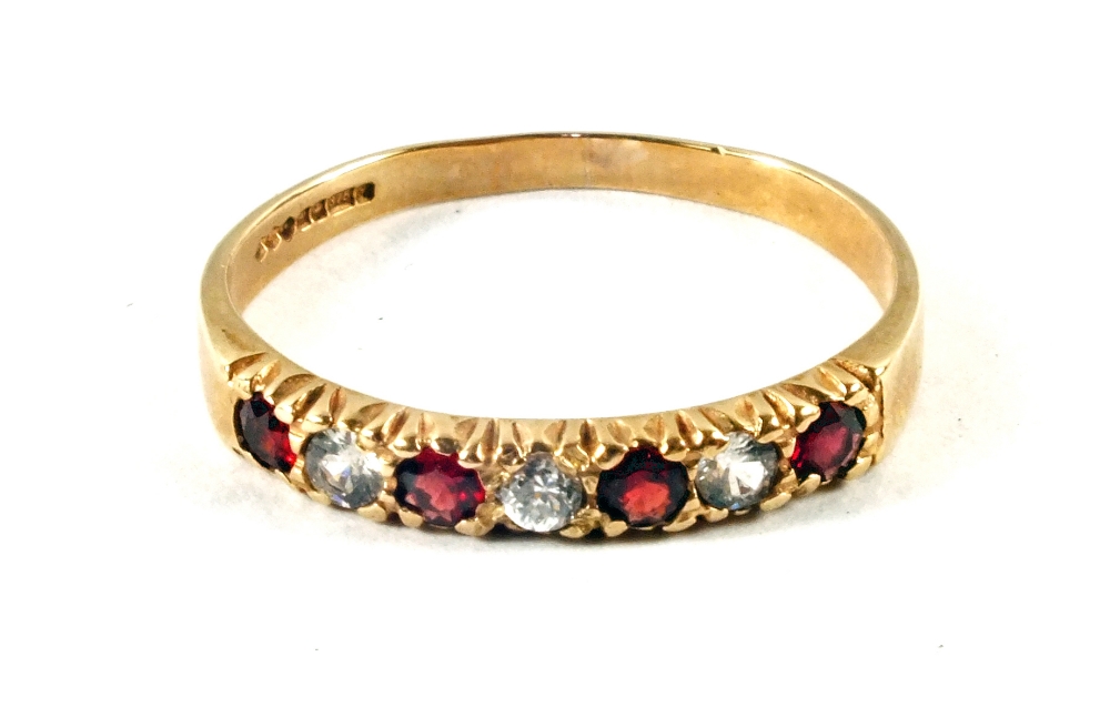 A 9ct Gold Garnet and white stone dress ring,