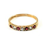 A 9ct Gold Garnet and white stone dress ring,