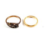 A 9ct Gold wedding band and an 18ct Gold paste set ring (one stone missing)