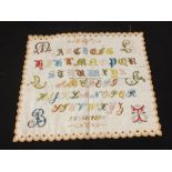 A multi coloured embroidered linen alphabet sampler,