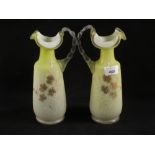 A pair of Burmese type yellow glass ewers with floral decoration,