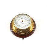 A Brass barometer marked John Barker & Co Ltd,