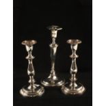 A pair of Sheffield plated candlesticks and a single plated candlestick with a hallmarked Silver