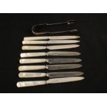 A set of eight Silver bladed Mother of Pearl tea knives and a pair of tongs