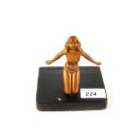 An Art Deco gilt metal kneeling unclad lady on stand