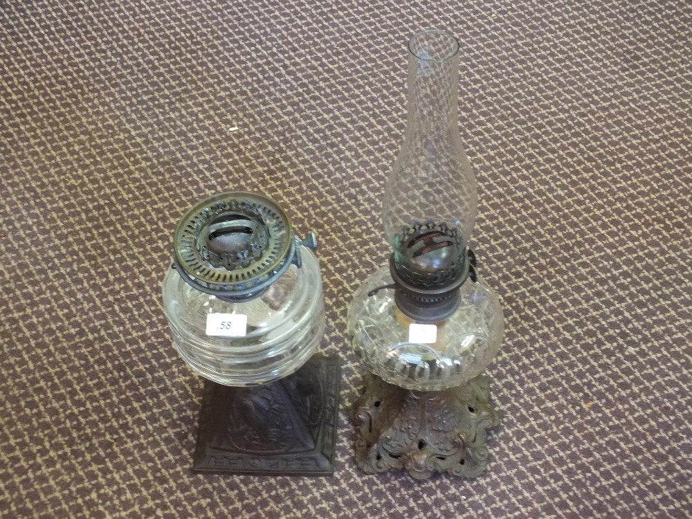 Two oil lamps with metal bases and cut glass bowls