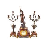 A striking clock garniture with spelter figure of Joan of Arc with floral painted porcelain dial on