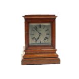 An Oak striking mantel clock with bevelled glass sides, dial marked T.