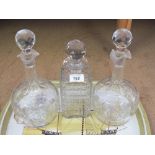 A pair of cut glass decanters and one other