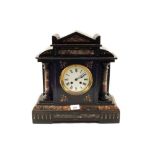 A black marble striking mantel clock