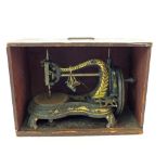 A late 19th Century Jones iron sewing machine with original Pine box