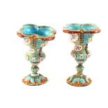 A pair of 19th Century French blue ground enamel vases with finely painted gilt and floral