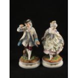 A pair of 19th Century French bisque figurines of a lady and gentleman,