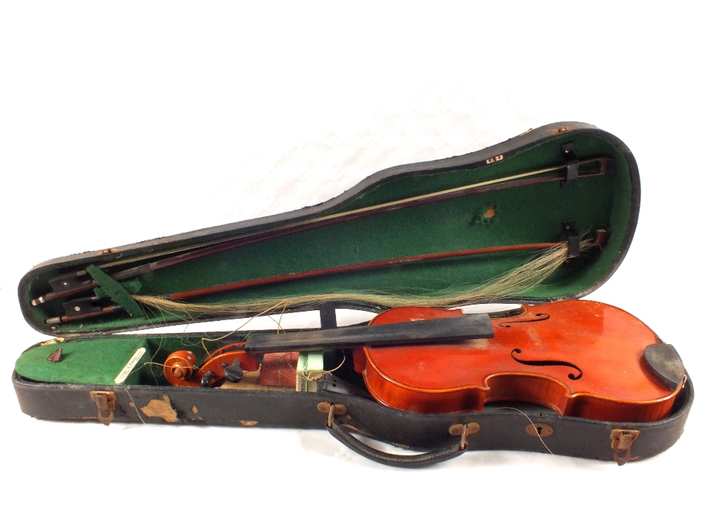 A cased violin and two bows