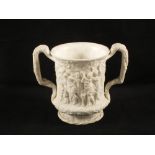 A Charles Meigh white stoneware loving cup with relief moulded Bacchanalian scenes