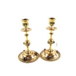 A pair of Arts and Crafts engraved Brass candlesticks each with six banded Agate roundalls,