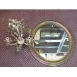 A Brass framed oval mirror and a wrought iron electrolier