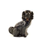 A 19th Century black glazed dog