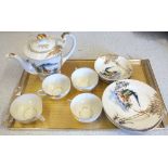 A Japanese eggshell tea set depicting Mount Fuji with ghost face bottom
